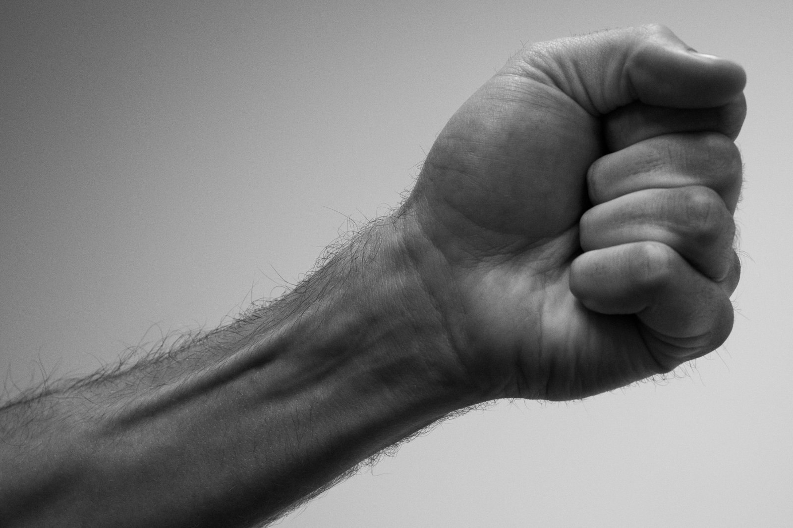 Clenched fist showing forearm tendons — isometric holds for tendon health
